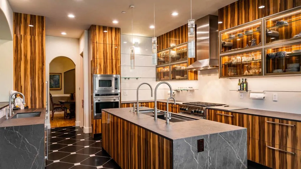 Elegant kitchen with zebrawood cabinets and black marble island Elegant kitchen with zebrawood cabinets and black marble island