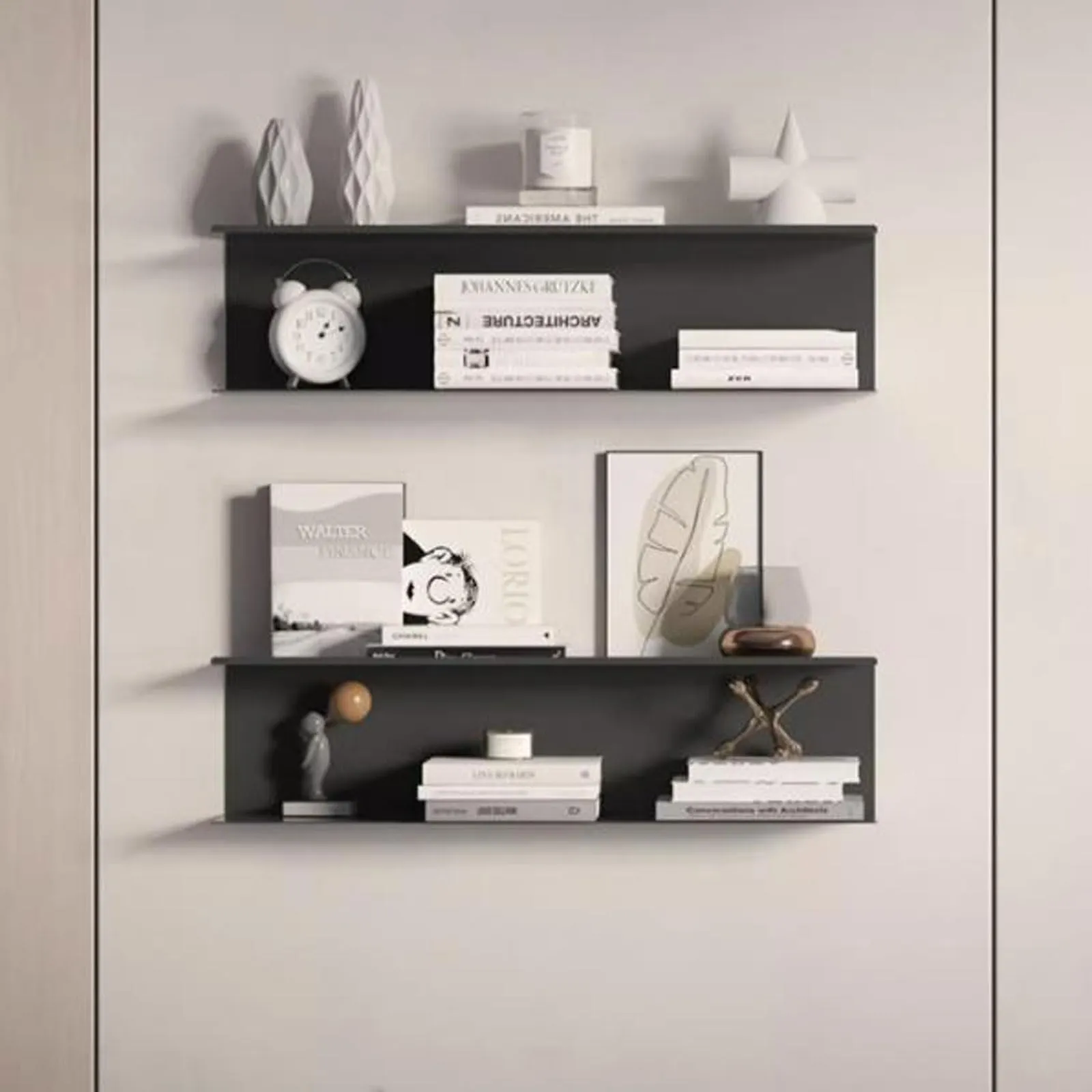 Floating black shelves with minimal decor against white wall Floating black shelves with minimal decor against white wall