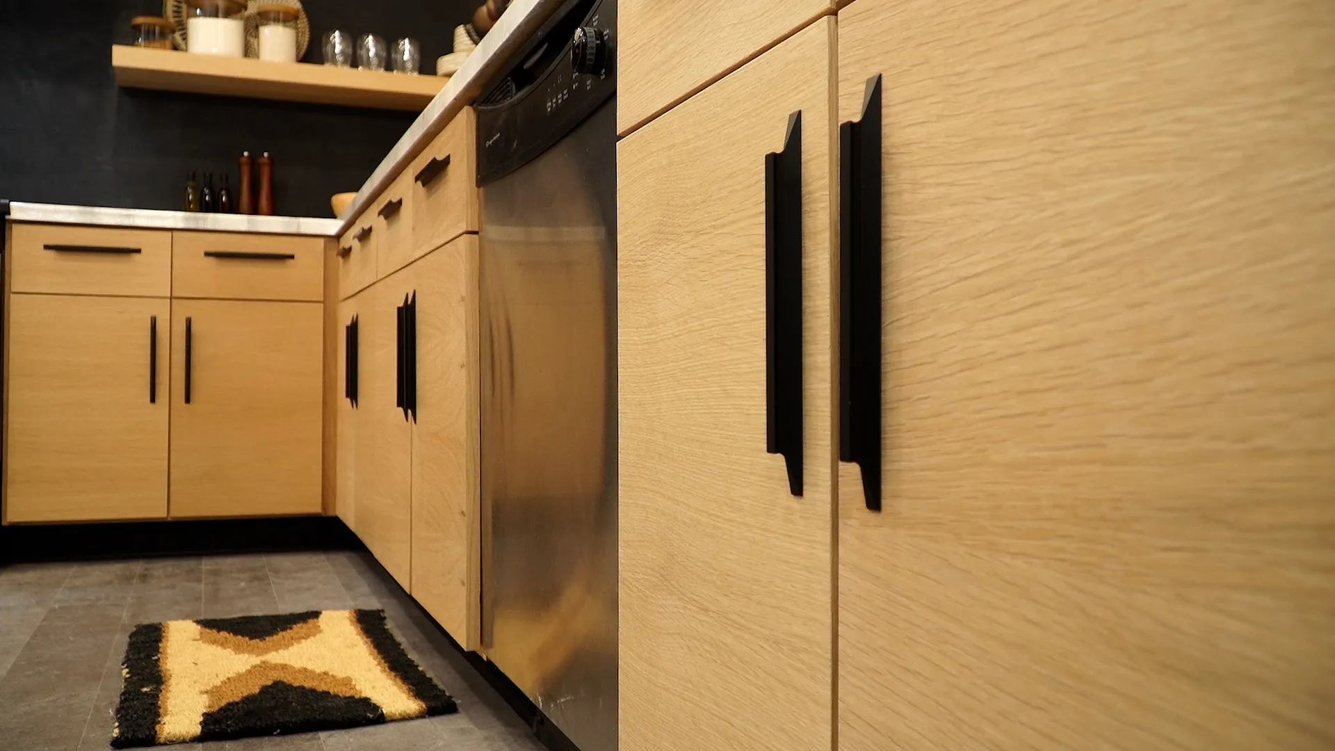 Light wood kitchen cabinets with black handles and dishwasher Light wood kitchen cabinets with black handles and dishwasher