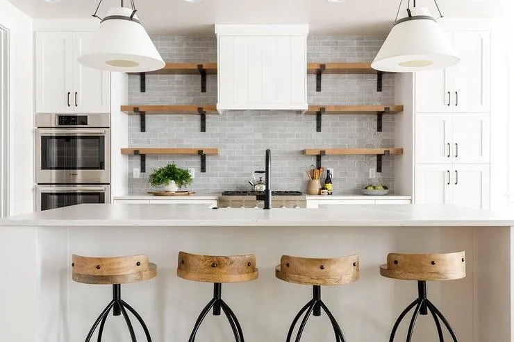 Minimalist kitchen with wooden stools and floating shelves Minimalist kitchen with wooden stools and floating shelves