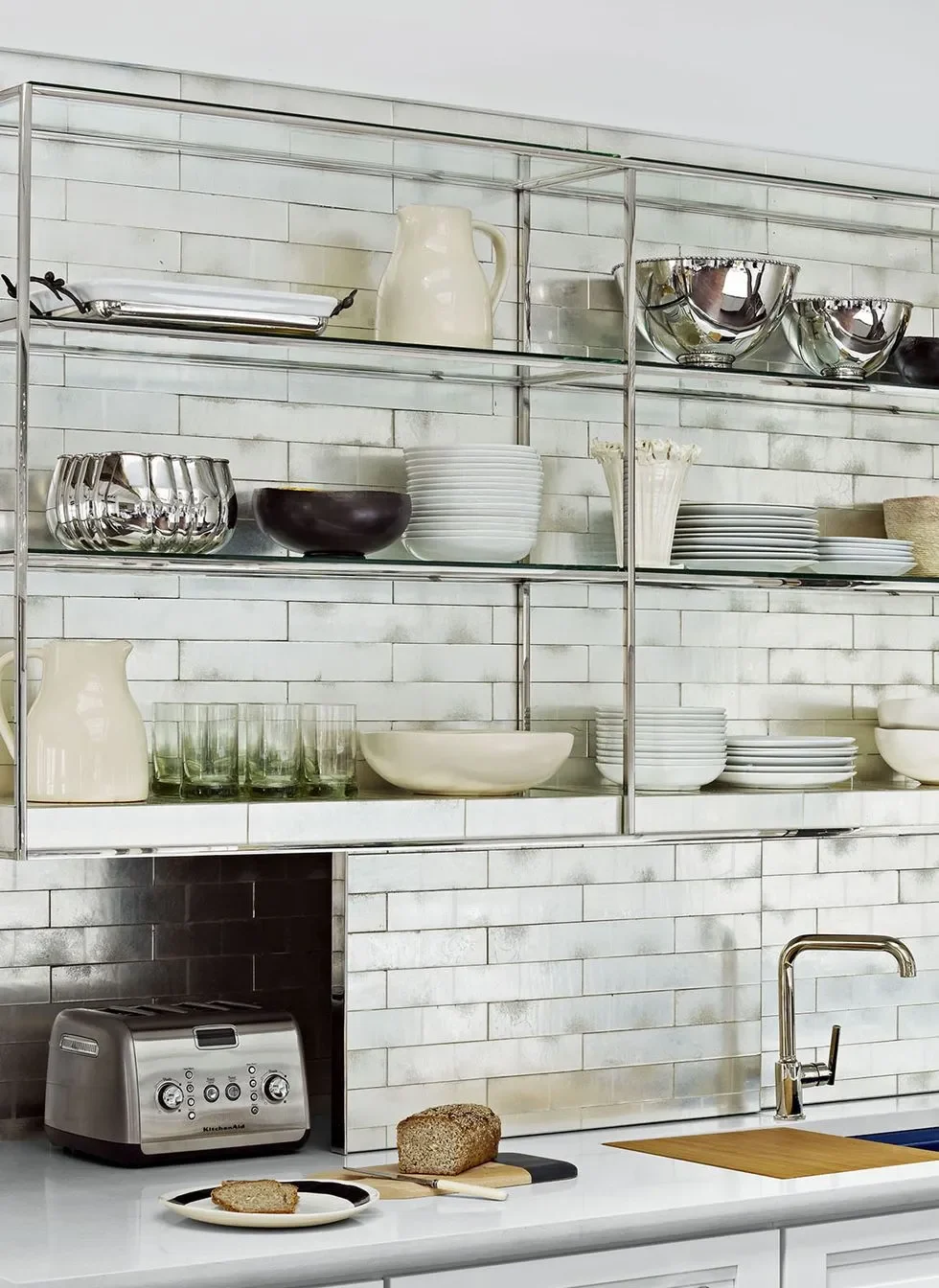 Modern kitchen shelves with a mix of white and silverware Modern kitchen shelves with a mix of white and silverware