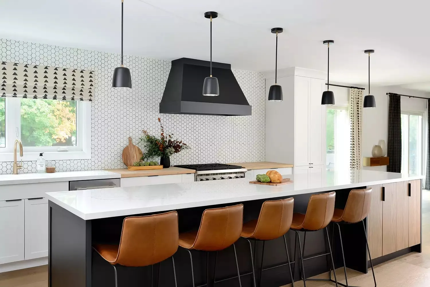 Modern kitchen with black island leather stools and white walls Modern kitchen with black island leather stools and white walls