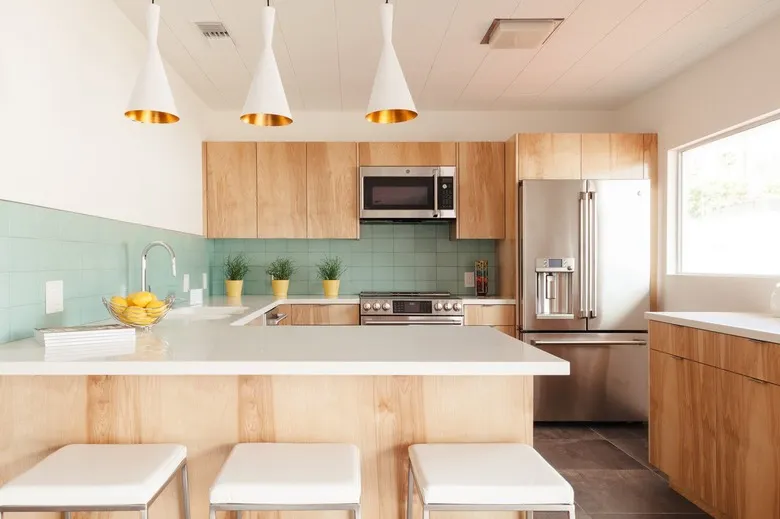Modern kitchen with light wood cabinets and mint green tile backsplash Modern kitchen with light wood cabinets and mint green tile backsplash