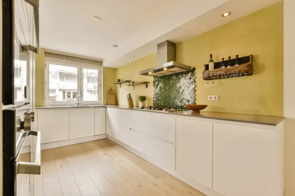 Modern kitchen with minimalist design featuring beige cabinets and bright lighting