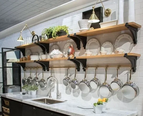 Open shelves displaying pots pans and dishes in a modern kitchen Open shelves displaying pots pans and dishes in a modern kitchen