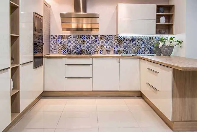 Sleek kitchen cabinets with blue patterned backsplash Sleek kitchen cabinets with blue patterned backsplash