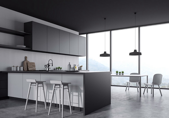 Sleek minimalist kitchen with large black and white island Sleek minimalist kitchen with large black and white island