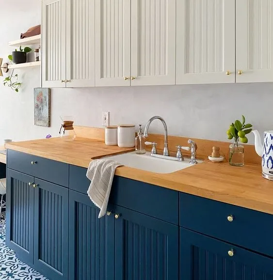 Two tone kitchen cabinets with wooden countertop and sink Two tone kitchen cabinets with wooden countertop and sink
