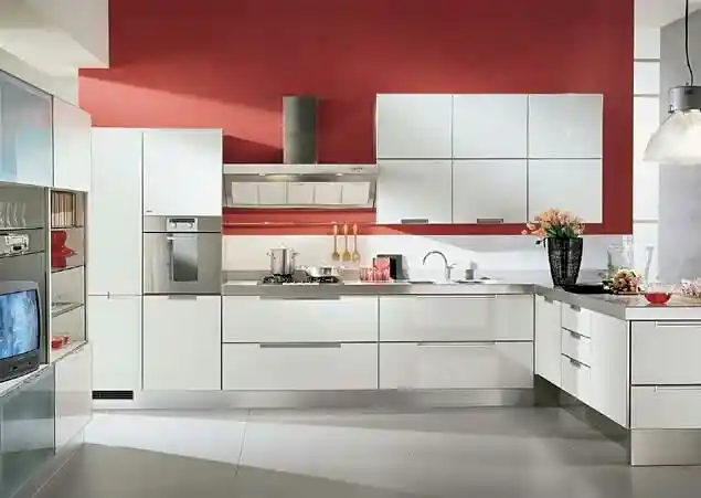 Contemporary white kitchen with red accent wall