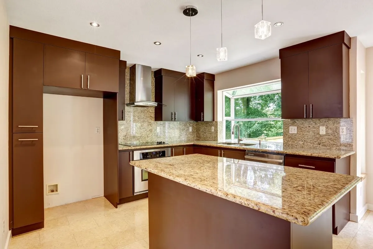 dark brown kitchen cabinet with white frame window Elegant kitchen with brown cabinets and granite countertops