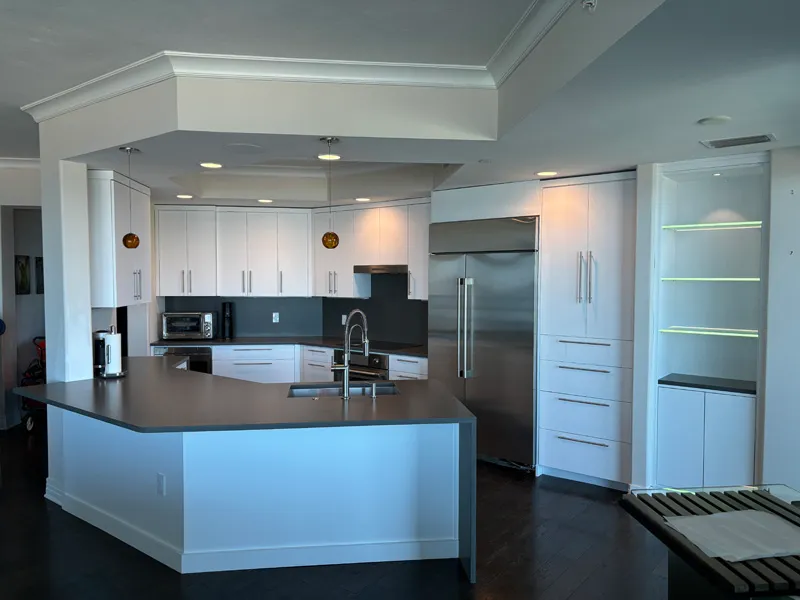 Bright white kitchen with black accents and modern appliances Modern Black and White Cabinets Crown Molding