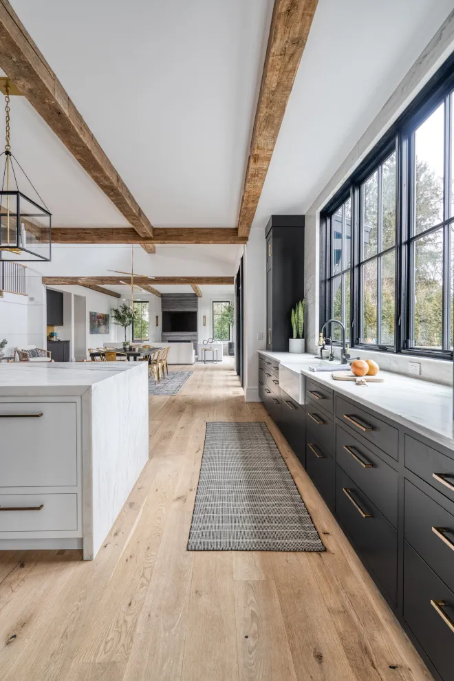 Farmhouse kitchen with black and white cabinets and wood accents Modern Black and White Cabinets Farmhouse Aesthetic
