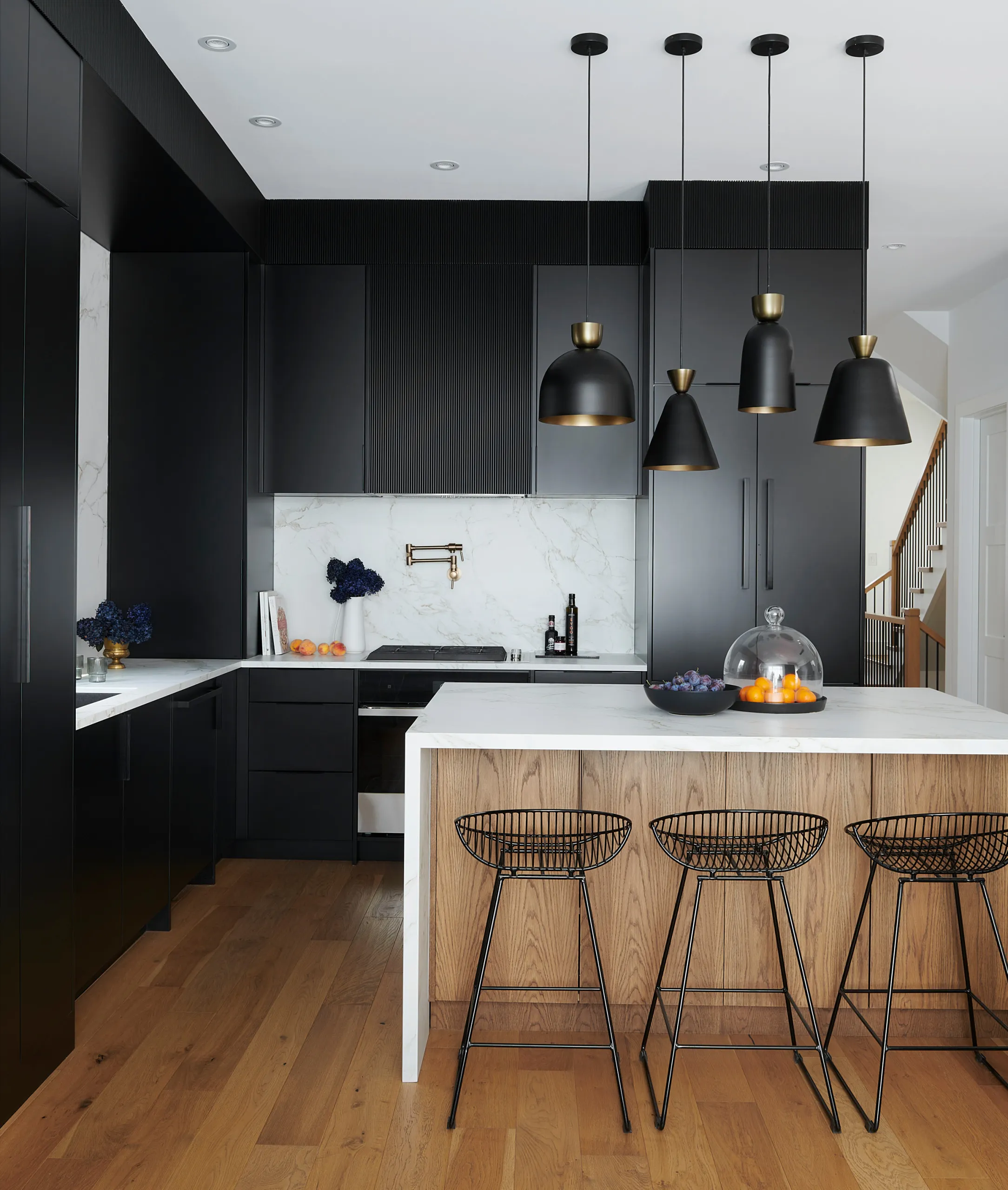 Modern black kitchen cabinets with pendant lights and island Modern Black and White Cabinets Layered Lighting