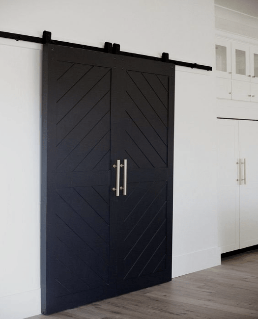 Cozy kitchen with white cabinets and thankful sign on the door Modern Black and White Cabinets Sliding Barn Door