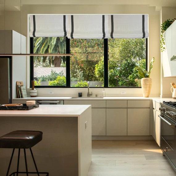 Bright kitchen with black and white cabinets and large window Modern Black and White Cabinets Window Treatments
