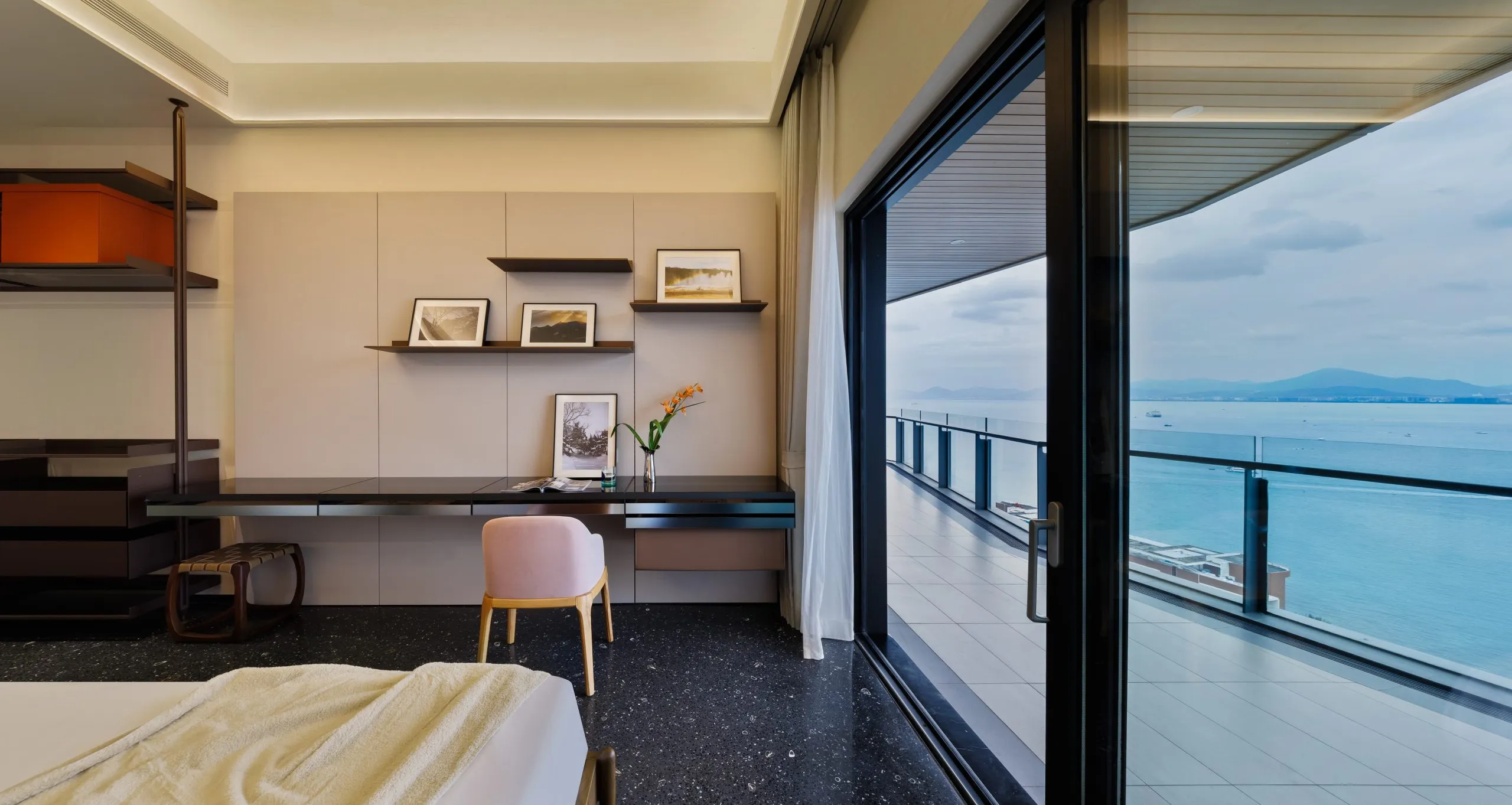 Modern dressing table with wall shelves and ocean view balcony Modern dressing table with wall shelves and ocean view balcony