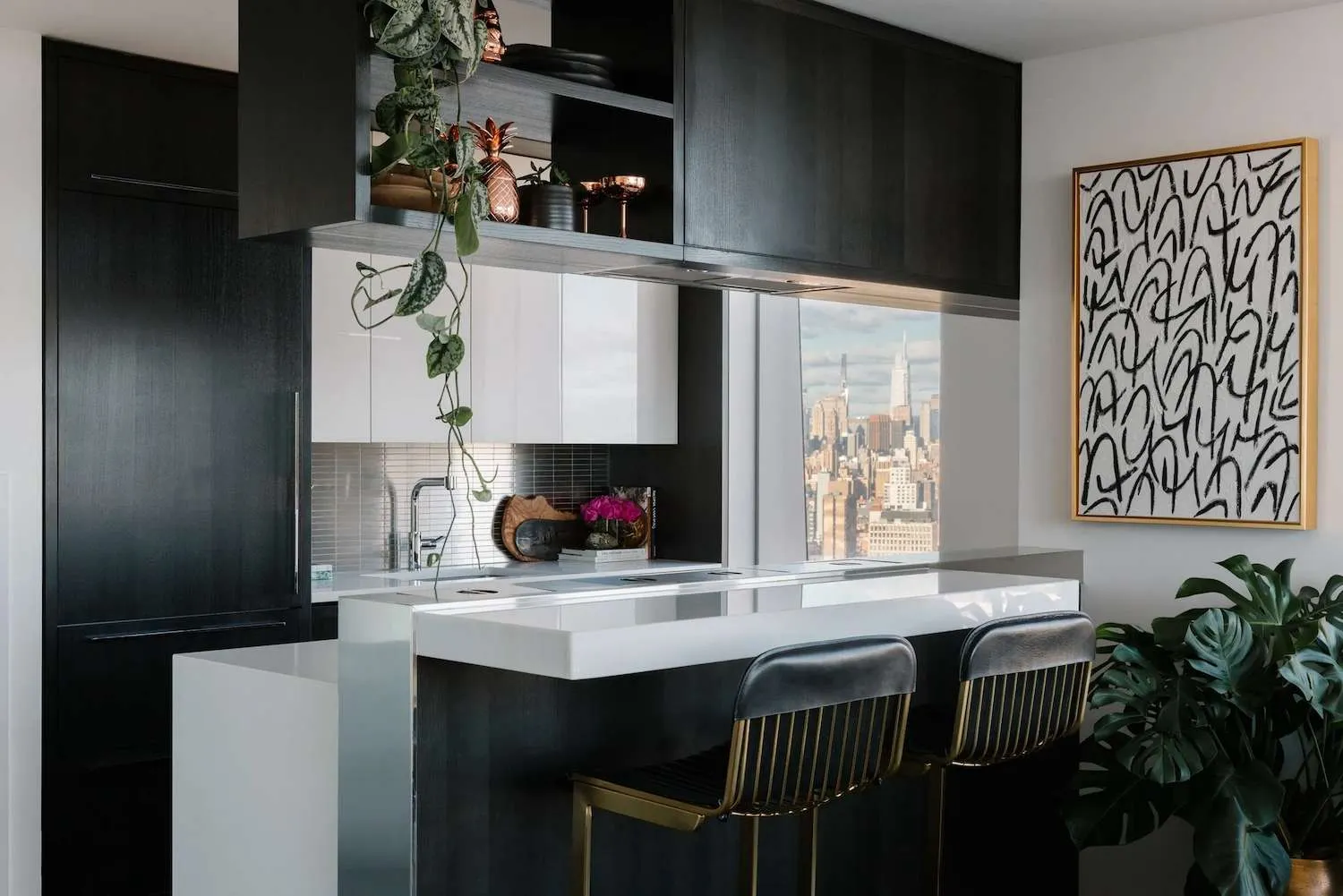 Farmhouse decor on top of white kitchen cabinets and appliances Modern kitchen with dark cabinets and city view through window