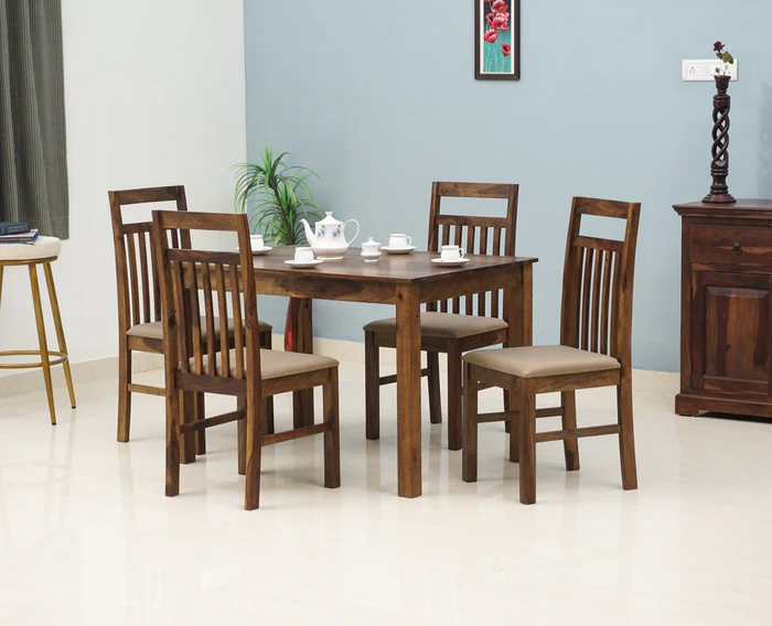 Compact wooden dining table with four chairs in minimalist room Compact wooden dining table with four chairs in minimalist room