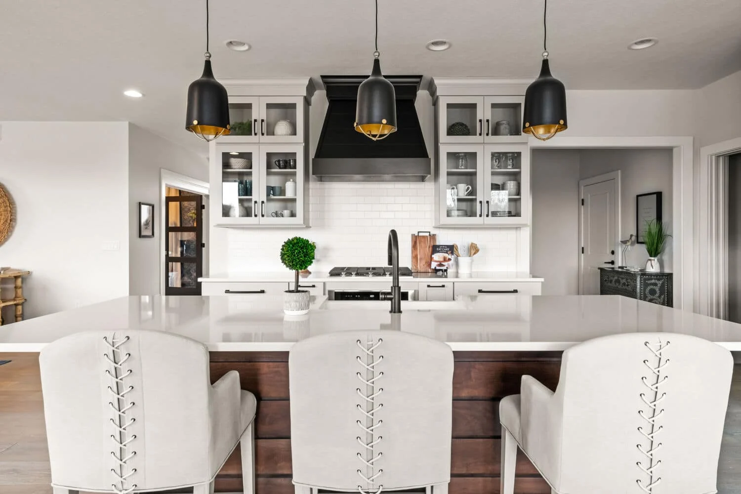 modern White kitchen cabinets with black hardware Dramatic Lighting