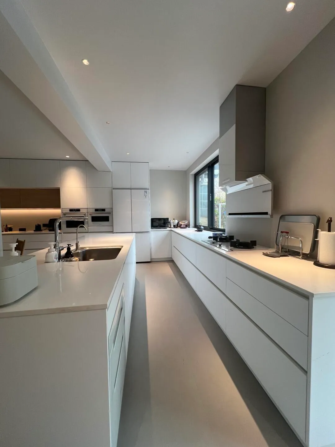 Bright white kitchen with modern cabinetry and natural lighting