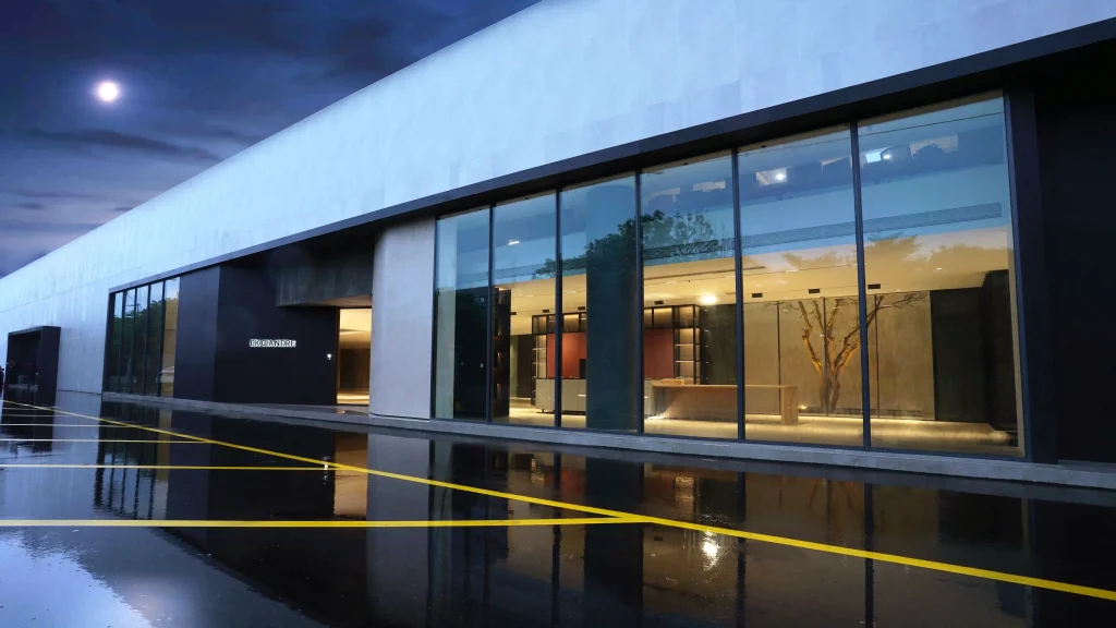 Modern glass building at night with interior lights glowing