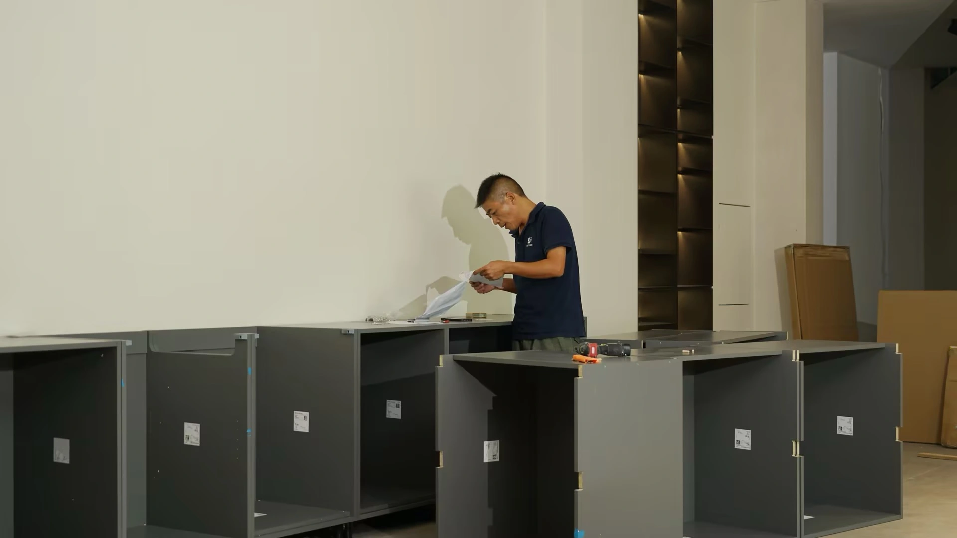 Person assembling furniture and reviewing assembly instructions