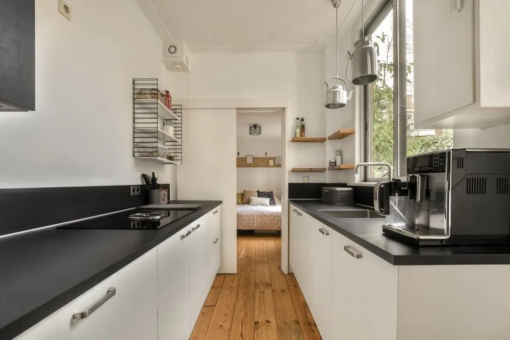 Sleek modern kitchen with grey cabinets and bright lighting