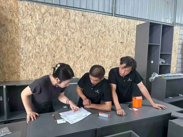 Team reviewing plans for kitchen cabinet installation