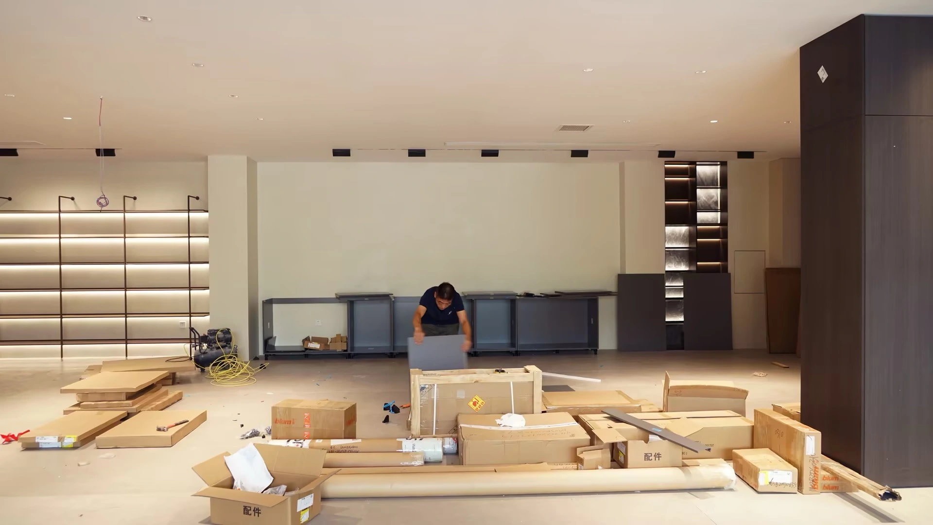 Worker assembling furniture in a spacious empty room