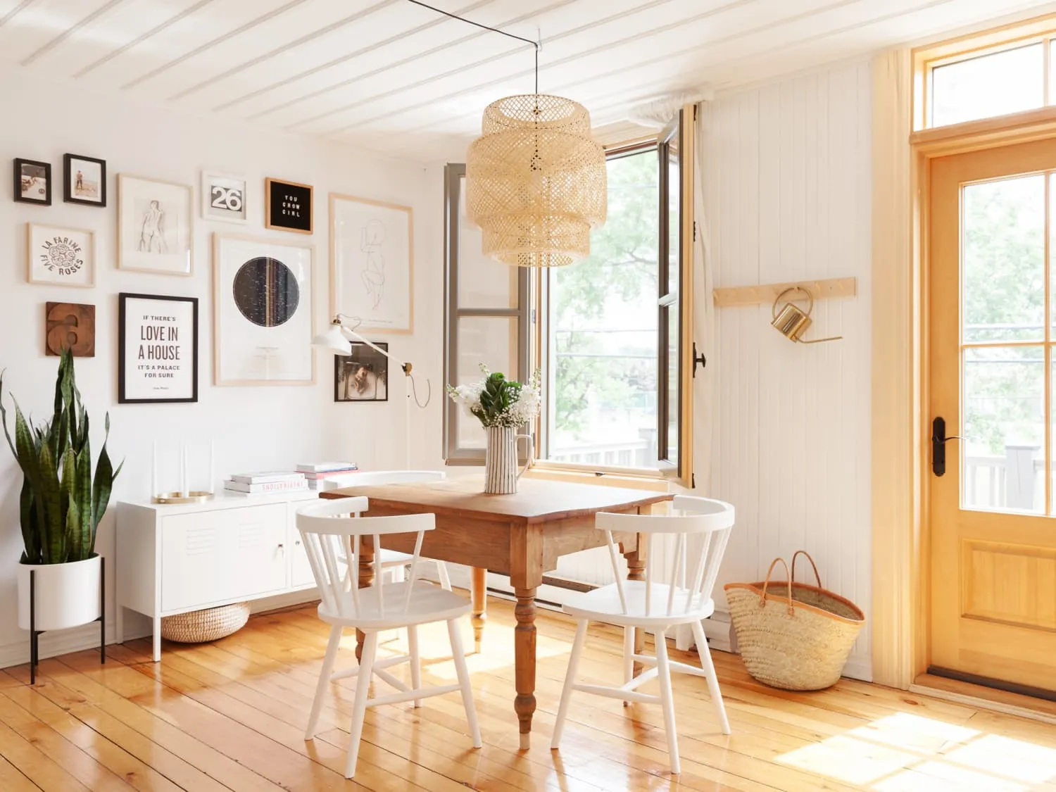 Dining area with a table chairs plants and wall art Dining area with a table chairs plants and wall art