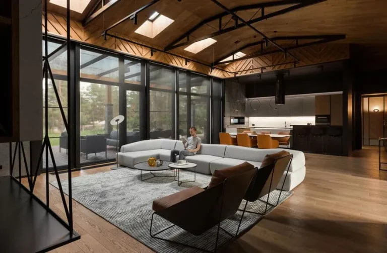 Cozy modern villa loft with man on light gray sectional