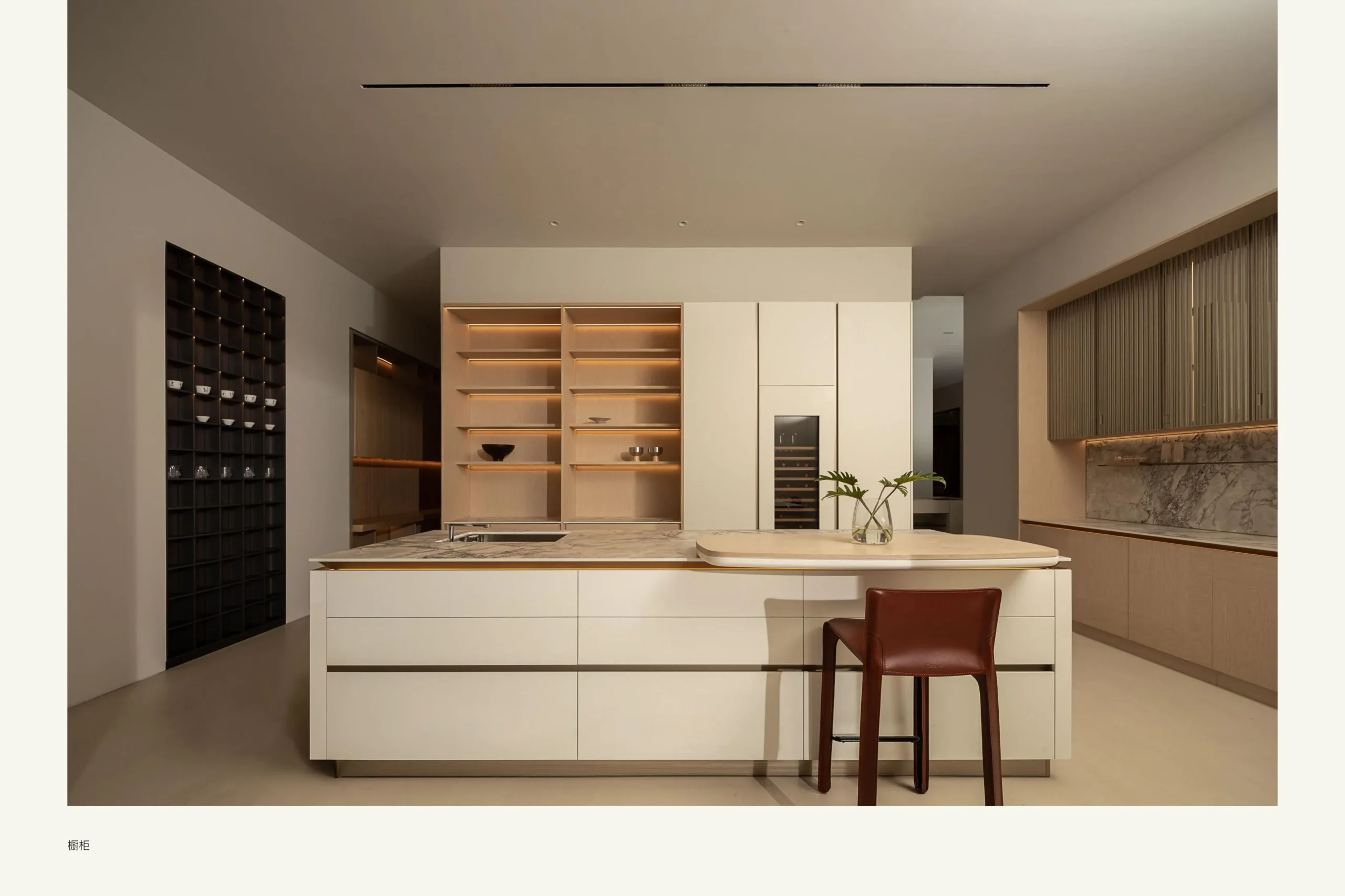 Singapore Showroom Central island backlit shelves and tall cabinetry