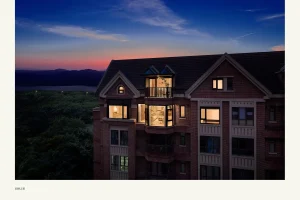 Singapore Villa Brick villa exterior lit at dusk with scenic mountain view