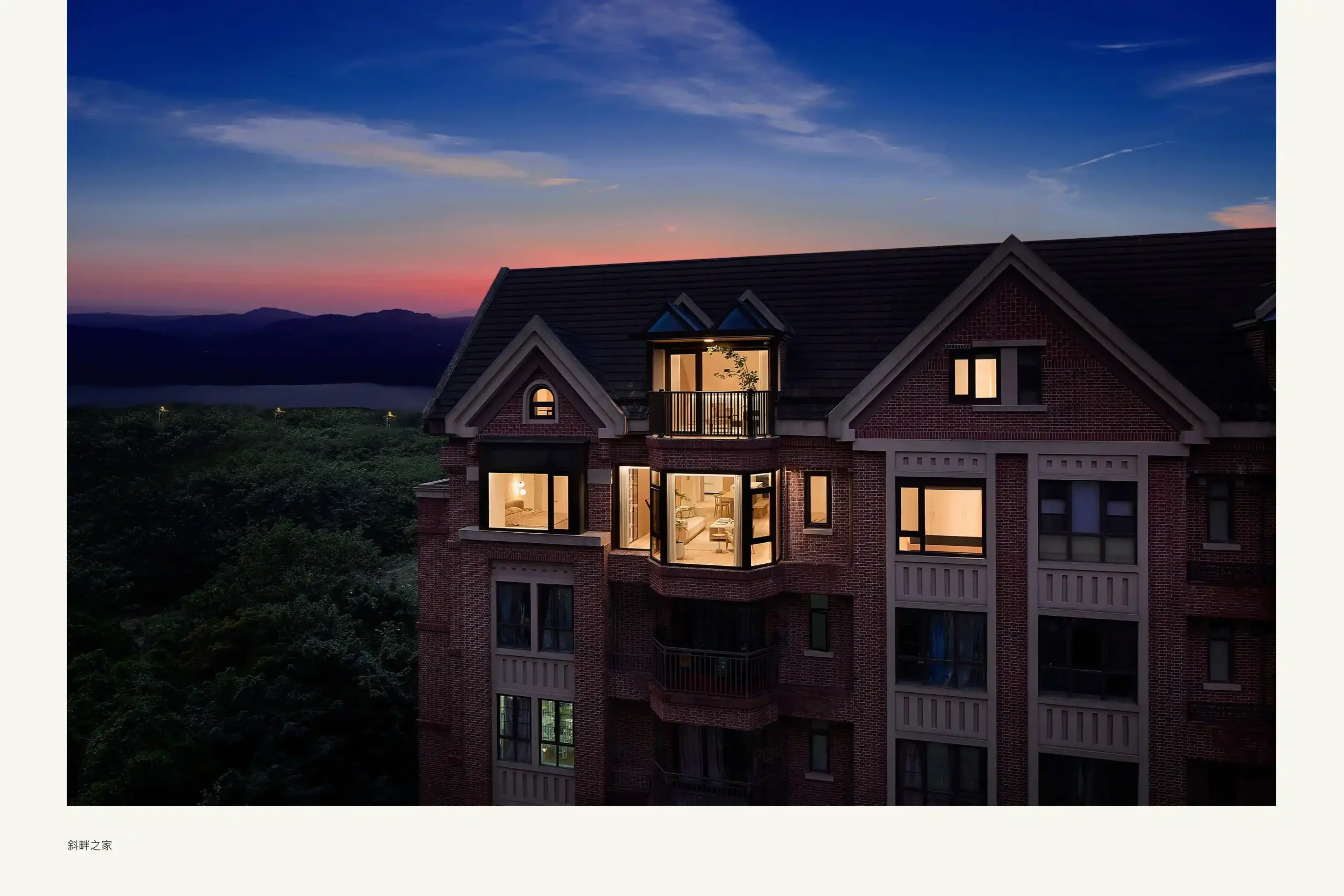 Singapore Villa Brick villa exterior lit at dusk with scenic mountain view