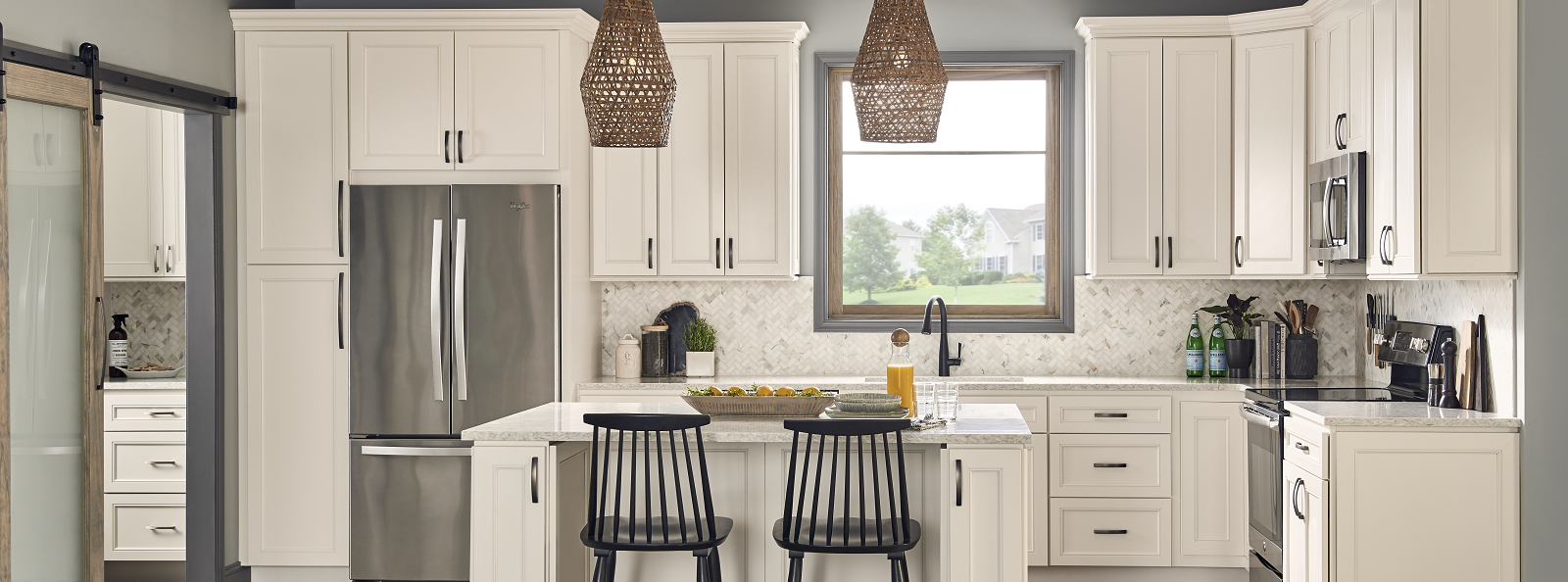 A bright kitchen with white cabinetry complemented by a stylish black refrigerator A bright kitchen with white cabinetry complemented by a stylish black refrigerator