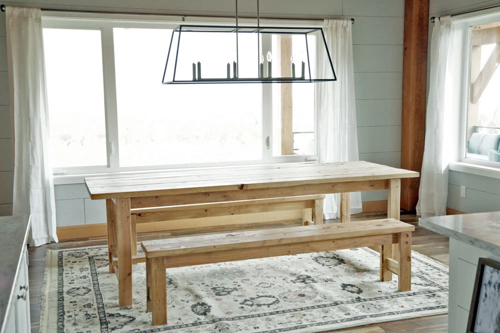 Bright dining area with simple wood table and bench seats