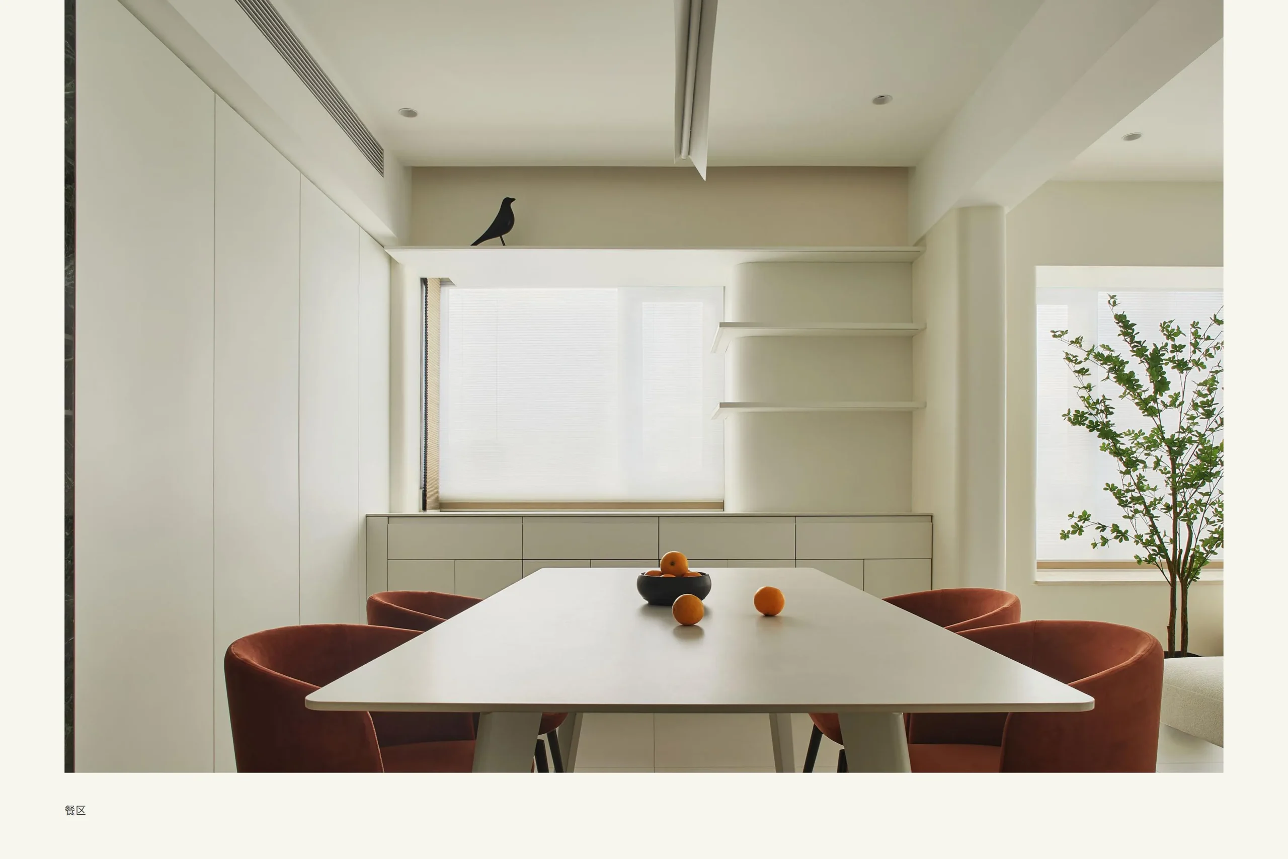 Dining room with orange chairs and built ins