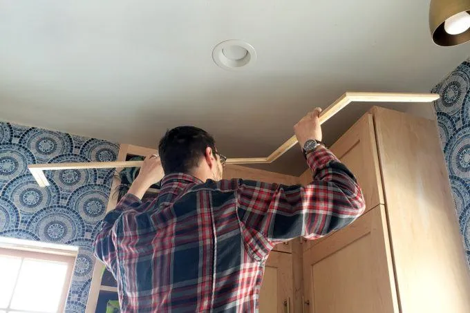 Installing trim and crown molding on cabinet top
