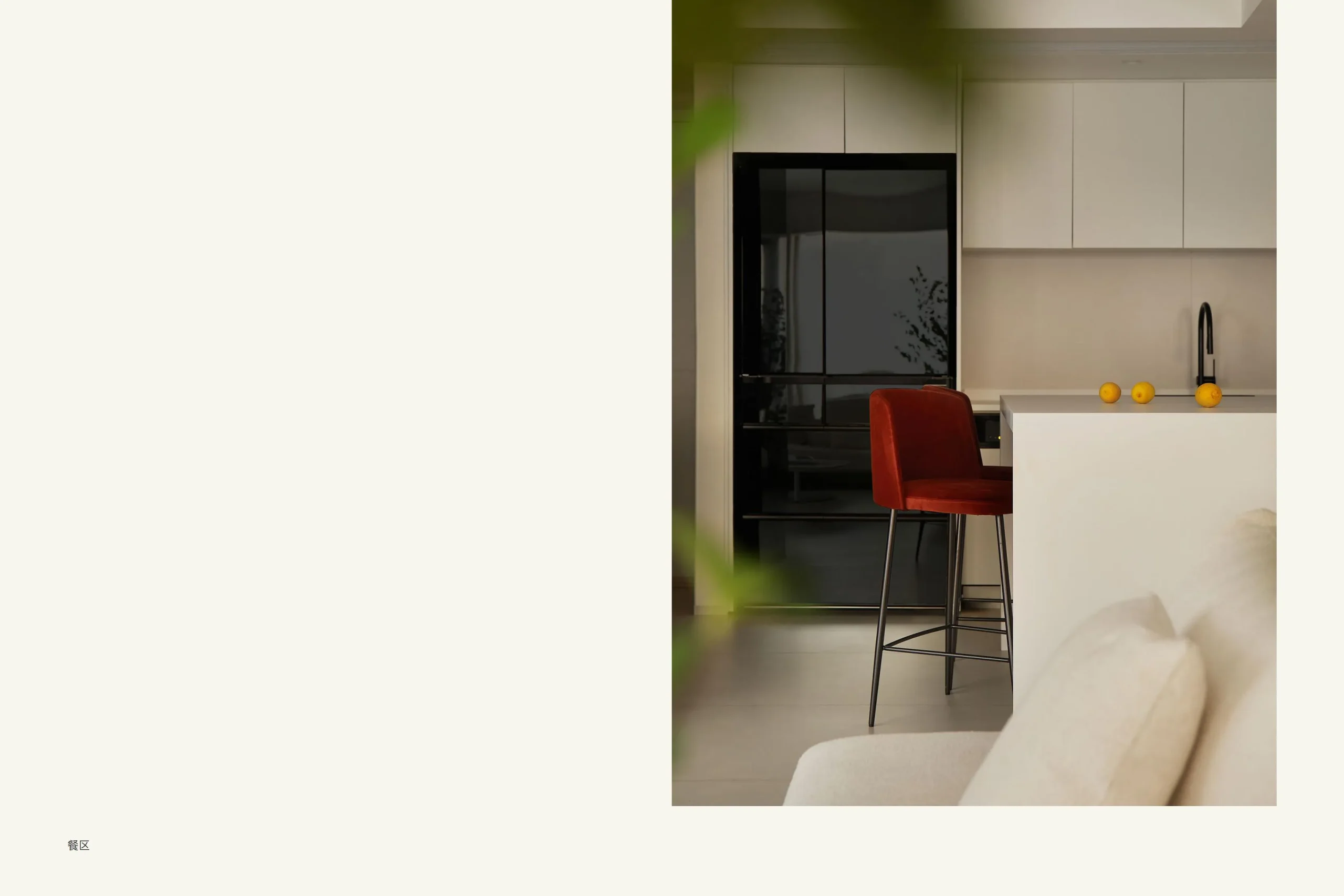 Kitchen island with red chair and black fridge