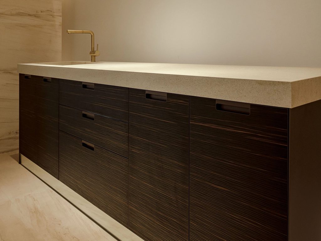 Close-up of European kitchen cabinet with sleek lines.