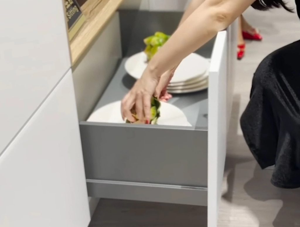 Italian Kitchen Cabinet with organized utensil drawer.
