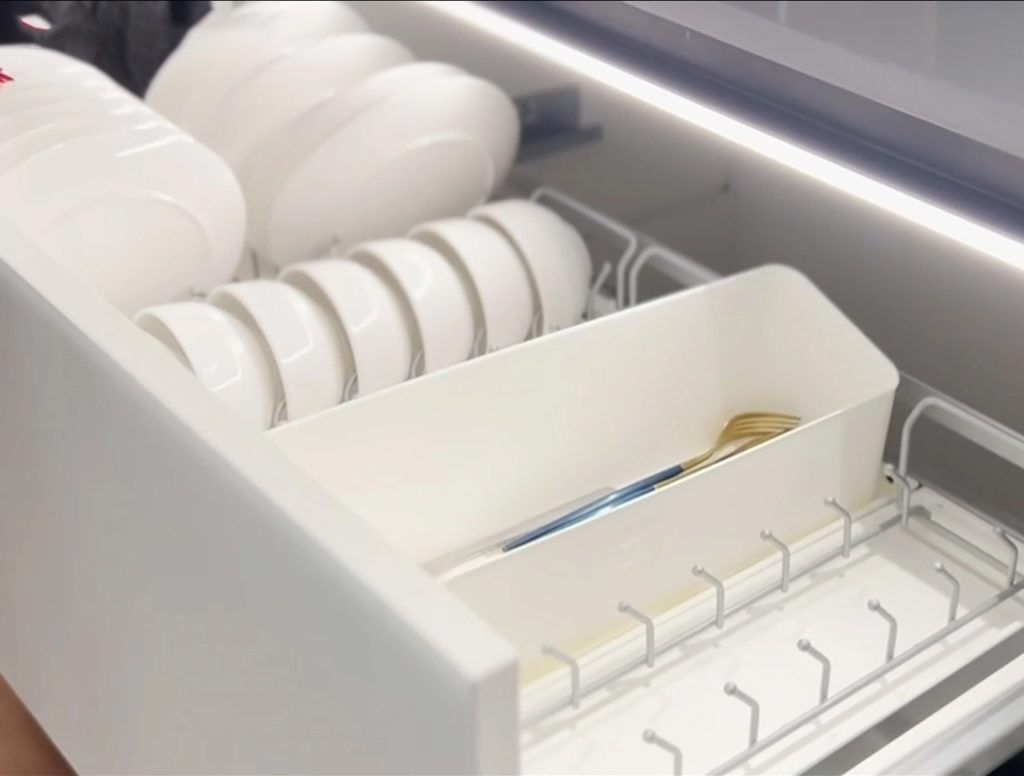 Italian Kitchen Cabinet drawer with neatly arranged plates.