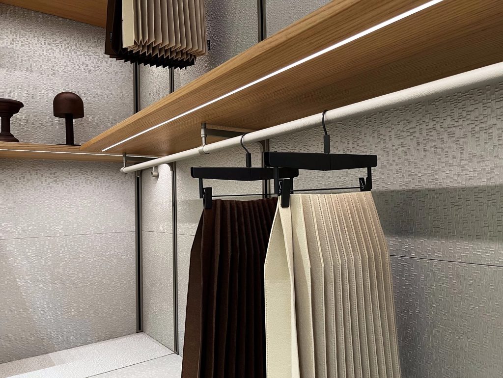 Walk-in wardrobe with pleated skirts hanging on rail
